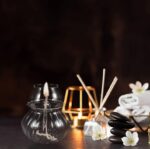 Elegant spa set with candles, stones, and flowers for relaxation and wellness. Perfect for creating a calming atmosphere at home or in a spa environment.