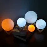 Set of five moon-shaped lamps with color-changing LED lights, perfect for home decor and educational purposes.