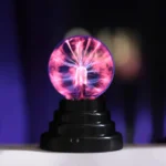 Plasma globe displaying colorful electrical discharges inside a glass sphere, showcasing high-voltage electrical phenomena for educational and decorative purposes.