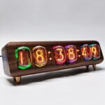Vintage nixie tube clock displaying time 08:38:19 on a wooden base, showcasing retro electronic design and colorful glowing numerals.