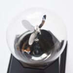 A close-up of a scientific glass bulb with a tiny propeller inside, showcasing a unique science gadget.