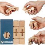 Hand holding wooden fidget cube puzzle pieces, demonstrating tactile stress-relief toys for focus and relaxation.