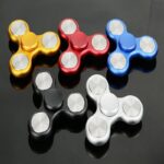 Colorful fidget spinners in gold, red, blue, black, and white, designed for stress relief and focus. Compact, lightweight, and easy to spin, perfect for educational and sensory activities.