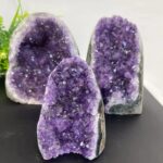 Vivid purple amethyst geode specimens with sparkling crystal interiors for educational and decorative purposes.