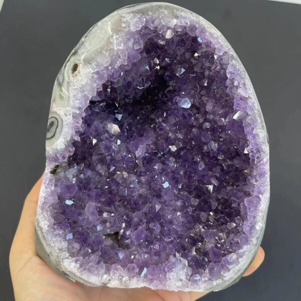 Close-up of a vibrant purple amethyst geode with sparkling crystals, showcasing natural mineral formations.