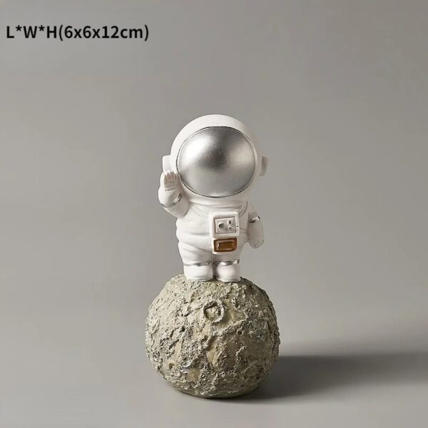 Astronaut figurine standing on a textured moon surface, perfect for science-themed decor and educational displays.