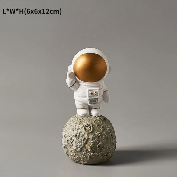 Small astronaut figurine with a gold helmet standing on a textured moon rock, ideal for science-themed decor or educational displays.