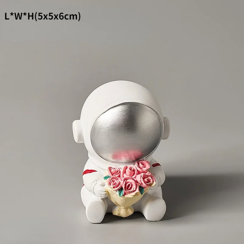 Science Gadgets | Science Decor & Educational Toys Shop A cute astronaut figurine holding a bouquet of pink roses, designed as a decorative science-themed item.