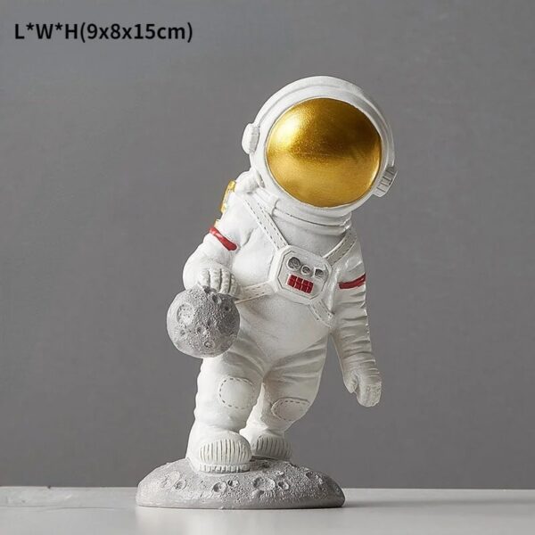 Cute astronaut figurine holding a moon rock, standing on a lunar surface model, perfect for space-themed decor and educational displays.