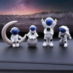 Astronaut figurines with space helmets and moon props set against a starry night sky, ideal for science decor and educational toys.