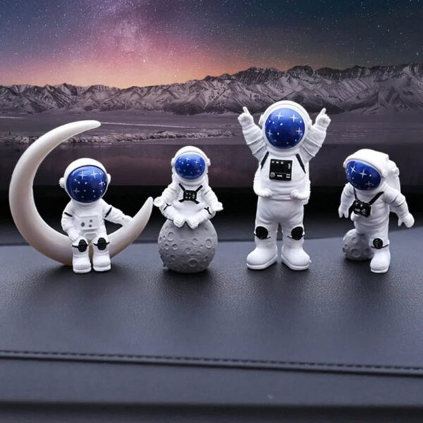 Astronaut figurines with space helmets and moon props set against a starry night sky, ideal for science decor and educational toys.