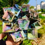 Vibrant iridescent geometric crystal sculpture featuring layered square and rectangular shapes, ideal for science-themed decor and educational displays.