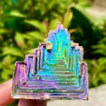 Vibrant rainbow titanium quartz crystal geode with iridescent colors and geometric formations, perfect for science decor and educational displays.