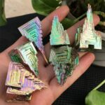 Holographic metal crystals with geometric shapes, vibrant iridescent finish, perfect for decor, educational displays, or collecting. Unique, shiny, and eye-catching design.