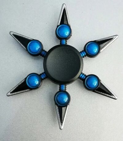 A star-shaped fidget spinner featuring a central black circle and six metallic points with blue spherical accents, designed for stress relief and focus.