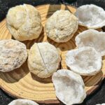 Handful of natural quartz geodes with rough exterior and sparkling interior, ideal for educational science projects or decorative displays.