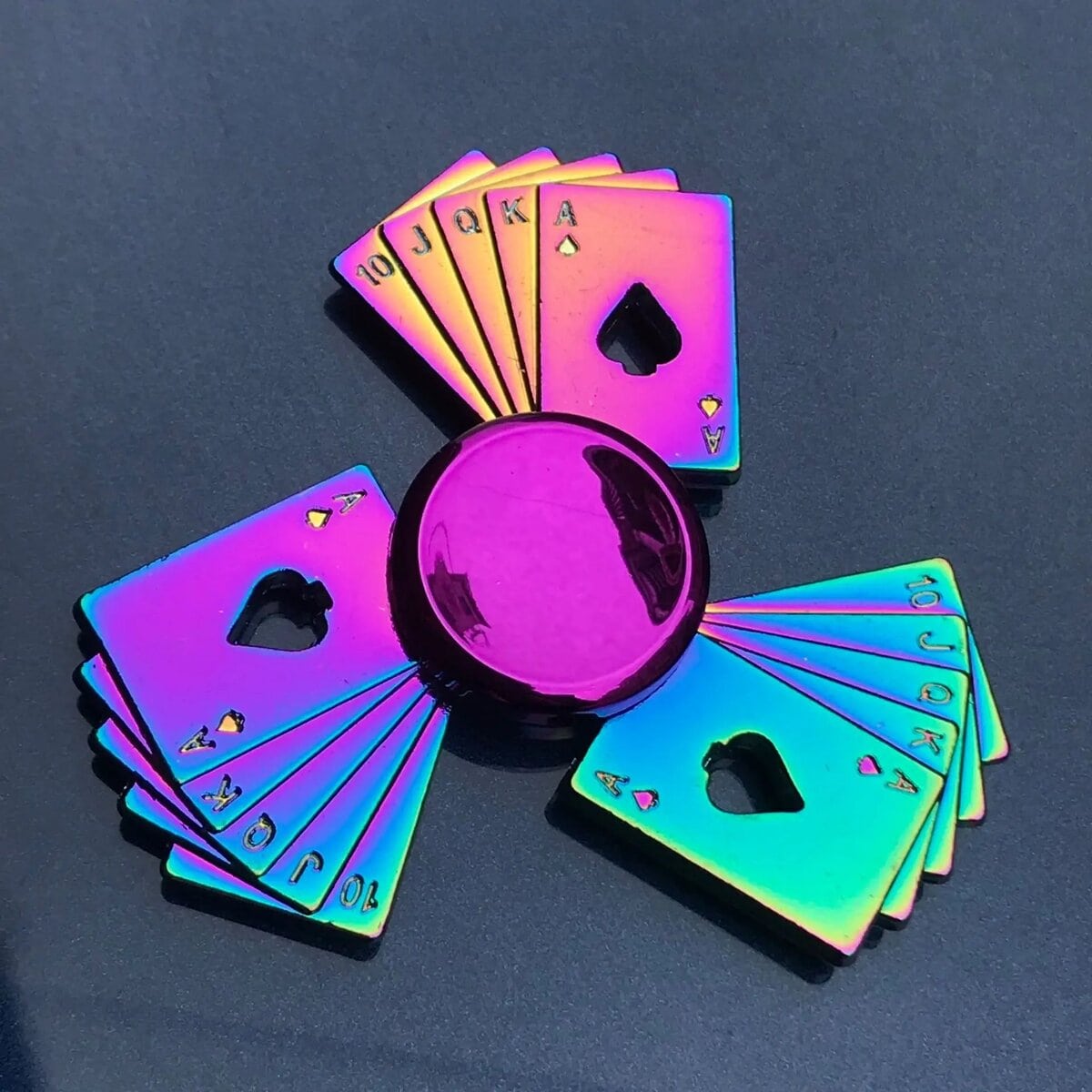 Colorful holographic playing cards with a shiny purple sphere in the center, arranged in a circular pattern on a dark background. Casino Fidget Spinner - Image 1