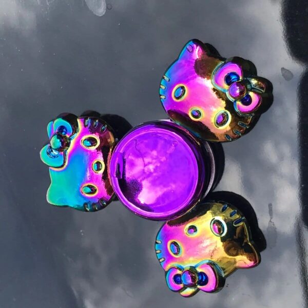 Colorful Hello Kitty-themed magnetic fidget spinner with a shiny, iridescent finish.