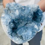 Large celestial blue geode crystal with sparkling, faceted surfaces and hollow interior, perfect for educational displays and decorative science decor.