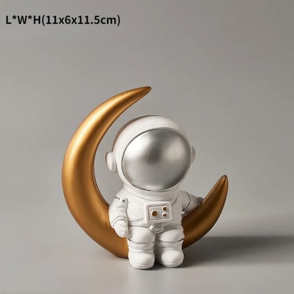 Adorable astronaut figurine sitting on a gold crescent moon, perfect for space-themed decor and educational displays.