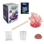 A colorful crystal growing science kit with a box, crystal sample, stirring stick, and other materials for educational experiments.