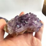 Amethyst crystal geode with vibrant purple crystals and a natural rock base, perfect for educational displays or decorative purposes.