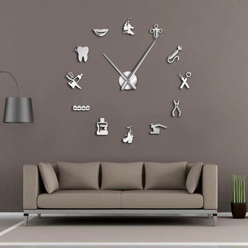 Modern wall clock with various science-themed icons on a gray wall. Unique science-themed wall clock with icons representing different scientific tools and symbols, perfect for a science decor or educational setting.