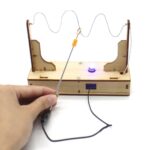 Educational magnetic electric circuit kit with wires, switch, and LED for science experiments and learning.