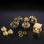 Brass gear and mechanical parts set for educational and STEM projects, including gears, washers, and a metal cube, ideal for science and engineering experiments.