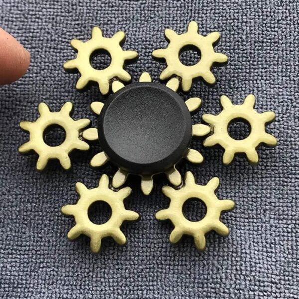 Educational magnetic gear puzzle with interlocking yellow gears and a central black knob, designed to teach children about mechanics and gear functions.