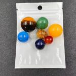 Brightly colored marbles in various sizes and patterns, packaged in a clear plastic bag.