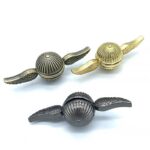 Set of three metallic winged shells with intricate ribbed designs, featuring gold and silver finishes, perfect for science-themed decor or educational displays.