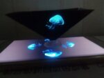 Vivid glowing jellyfish model with LED lighting on a black stand, showcasing bioluminescence for educational and decorative purposes.