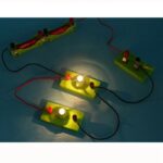 Interactive science experiment with light bulbs and wires demonstrating electrical circuits for educational purposes.