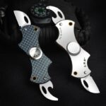 Close-up of a Spyderco Karahawk tactical folding knife featuring curved blades, textured handle, and compact design, ideal for outdoor and tactical use.