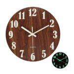 Elegant wooden wall clock featuring luminous numbers and hands for easy reading in low light conditions.