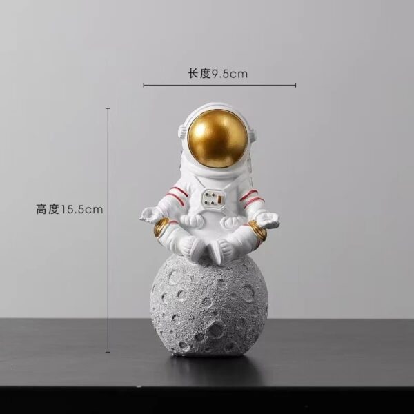 Cute astronaut figurine sitting on a moon surface model, perfect for science decor and educational toys. Ideal for space-themed classrooms or science enthusiasts.