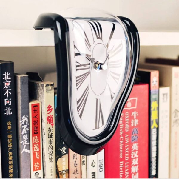 A melting clock sculpture inspired by Salvador Dalí's surrealist art, draped over a row of books on a shelf. The clock appears to be melting and distorted, creating a dreamlike and artistic visual.