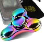 Colorful rainbow-finished fidget spinner with three spinning arms, designed for stress relief and focus enhancement, placed next to a metallic case.