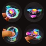 Colorful LED light fidget spinner spinning in the dark, showcasing vibrant rainbow hues and smooth motion for stress relief and focus.