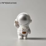 A cute astronaut figurine with a silver reflective helmet, white suit, and a small control panel on the chest, designed for science-themed decor and educational purposes.