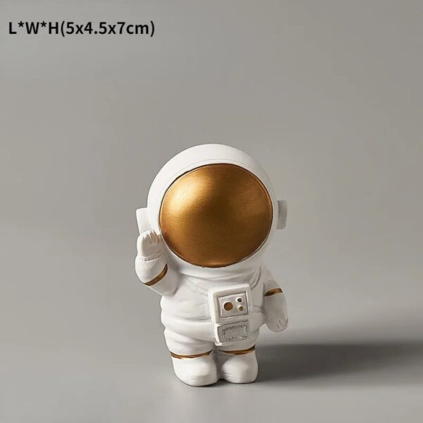 A cute astronaut figurine with a gold helmet, white suit, and detailed accessories, perfect for science-themed decor or educational displays.