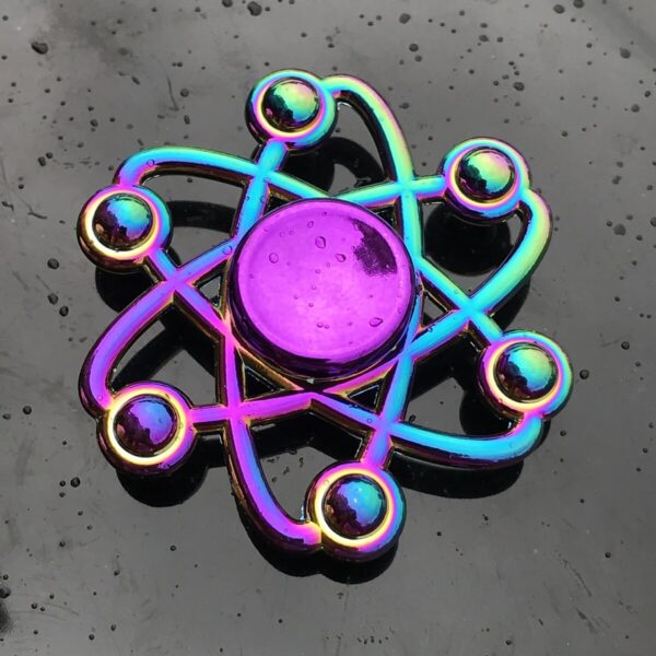 Vibrant rainbow-colored atom model with orbiting electrons, perfect for science-themed room decoration or educational displays.