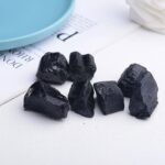 Natural black tourmaline stones used for energy cleansing, protection, and healing in spiritual practices and holistic wellness routines.