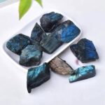 Natural blue labradorite stones with iridescent flashes, perfect for educational displays or decorative purposes. Each piece showcases vibrant blue hues and unique mineral patterns.