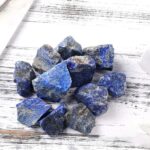 Natural blue lapis lazuli stones with gold flecks, ideal for science decor, educational projects, and mineral collections. Perfect for enhancing science-themed displays and learning environments.