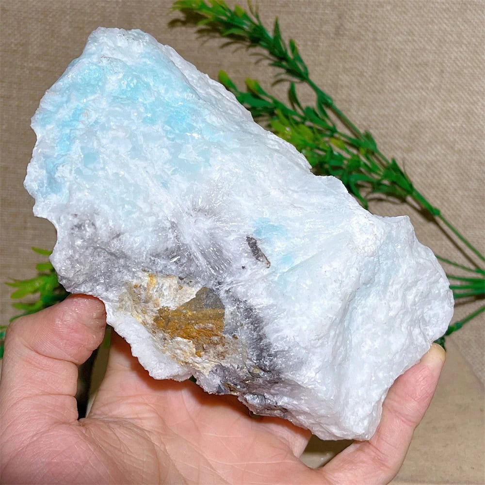White Quartz Crystal Rock for Science and Education Hand holding a large white quartz crystal rock, ideal for science experiments, educational displays, and decorative purposes in science-themed decor.