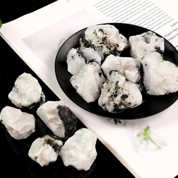 Close-up of white mineral rocks with black inclusions on a black and white background, showcasing natural mineral textures and formations.