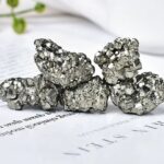 Close-up of shiny pyrite mineral rocks showcasing metallic luster and cubic crystal formations, ideal for science decor and educational purposes.