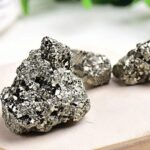 A close-up of shiny pyrite rocks showcasing their metallic appearance and cubic crystal structure, perfect for educational science displays or decorative purposes.